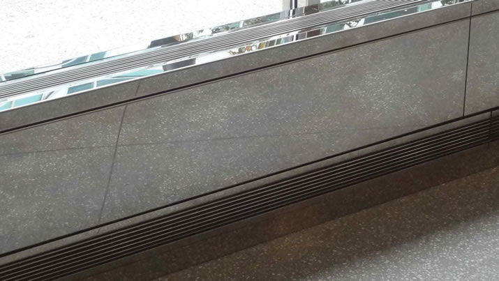 Mirror polished stainless steel enclosure top and return grilles at New York City Hospital Lobby